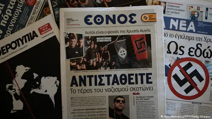 A front-page picture in centre-left daily Ethnos (C), shows the self-confessed killer at a Golden Dawn summer camp gathering on September 19, 2013. Musician Pavlos Fyssas was fatally stabbed in the working-class Athens district of Keratsini on September 18 by a 45-year-old truck driver who later allegedly confessed his Golden Dawn affiliation to police. The victim's family said that Fyssas and a small group of friends had been ambushed by a large gang of Golden Dawn supporters outside a cafeteria. The title of the paper reads 'The monster of Nazism kills -- resist'. AFP PHOTO / ARIS MESSINIS (Photo credit should read ARIS MESSINIS/AFP/Getty Images)