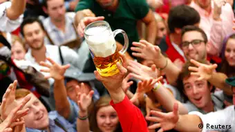 Visitors reach for the first mug of beer after the tapping of the first barrel during the opening ceremony for the 180th Oktoberfest at the Hofbraeu tent in Munich September 21, 2013. Millions of beer drinkers from around the world will come to the Bavarian capital over the next two weeks for the 180th Oktoberfest, which starts today and runs until October 6. REUTERS/Michael Dalder (GERMANY - Tags: ENTERTAINMENT SOCIETY)