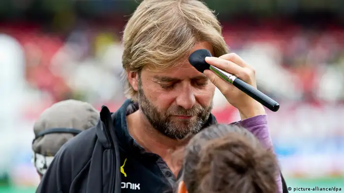 Dortmund head coach Jürgen Klopp has make-up applied for apre-match interview, but it could not save his side's blushes as they failed to overcome Nuremberg. Held 1-1, the draw opened the door for Bayern at the top of the Bundesliga. Photo: dpa