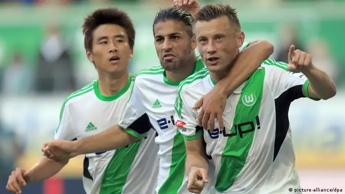 Wolfsburg striker Ivica Olic (right) celebrates the first of his two goals in his side's 2-1 win over Hoffenheim with team-mates Koo Ja-Cheol (left) and Ricardo Rodriguez (centre). Olic's double takes his tally to the season to four, and also moves Wolfsburg up to sixth on the table. Photo: dpa