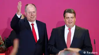 Peer Steinbrueck (L), top candidate of the Social Democratic Party (SPD) and party leader Sigmar Gabriel address supporters after first exit polls in the German general election (Bundestagswahl) at the party headquarters in Berlin September 22, 2013. REUTERS/Thomas Peter (GERMANY - Tags: ELECTIONS POLITICS)