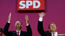Peer Steinbrueck (L), top candidate of the Social Democratic Party (SPD) and party leader Sigmar Gabriel address supporters after first exit polls in the German general election (Bundestagswahl) at the party headquarters in Berlin September 22, 2013. REUTERS/Michael Dalder (GERMANY - Tags: ELECTIONS POLITICS)