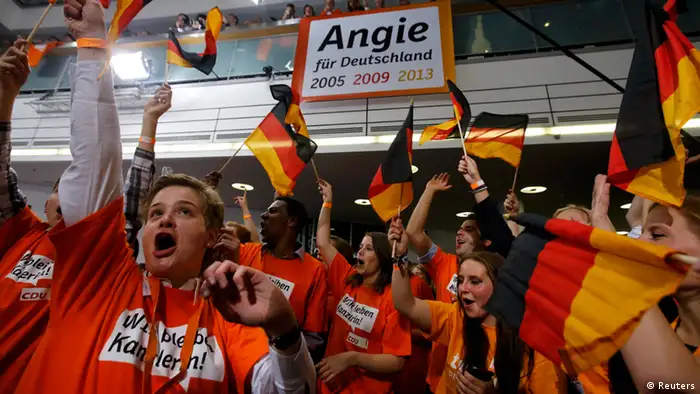 Supporters of the Christian Democratic Union (CDU) celebrate after first exit polls in the German general election (Bundestagswahl) at the CDU party headquarters in Berlin September 22, 2013. Chancellor Angela Merkel won a landslide personal victory in a German election on Sunday, putting her within reach of the first absolute majority in parliament in half a century, a ringing endorsement of her steady leadership in the euro crisis. REUTERS/Fabrizio Bensch (GERMANY - Tags: POLITICS ELECTIONS)