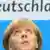 Bundeskanzlerin Angela Merkel schaut nach oben, im Hintergrund ist das Wort Deutschland zu lesen - Foto: Alexander Hassenstein