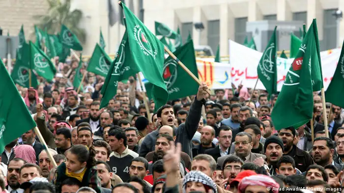 Jordanians and Palestinians chant slogans and wave Muslim Brotherhood flags during a demonstration in the Jordanian capital Amman against Israel's deadly assault on the Gaza Strip March 2, 2008. More than 5,000 demonstrators marched peacefully from the headquarters of the Islamist-dominated trade unions to the parliament building in the city centre to protest Israel's deadly assault on the Hamas-run Gaza Strip. AFP PHOTO/AWAD AWAD (Photo credit should read AWAD AWAD/AFP/Getty Images)