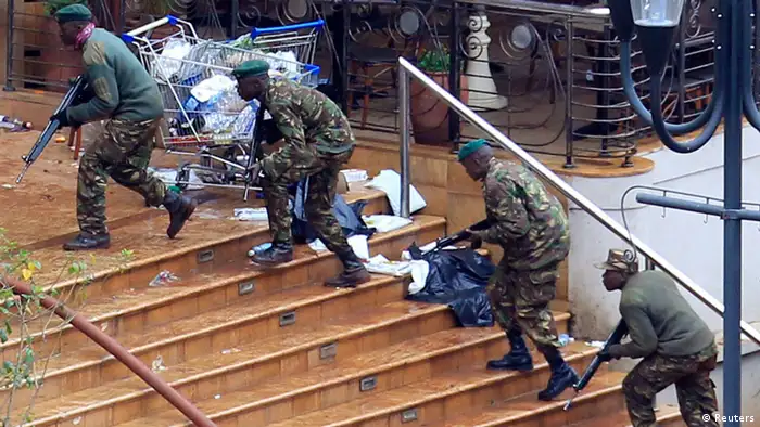 Kenya Defence Forces soldiers take their position at the Westgate shopping centre, on the fourth day since militants stormed into the mall, in Nairobi September 24, 2013. Somalia's al Shabaab Islamist group said on Tuesday there were countless dead bodies in the Westgate shopping centre as security forces searched for militants still holed up in the complex after a weekend attack that authorities say killed 62 people. REUTERS/Noor Khamis (KENYA - Tags: CIVIL UNREST CRIME LAW MILITARY)