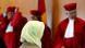 Woman in headscarf from behind, facing three judges who are blurry Photo: Uli Deck dpa/lsw Woman in headscarf from behind, facing three judges who are blurry Photo: Uli Deck dpa/lsw