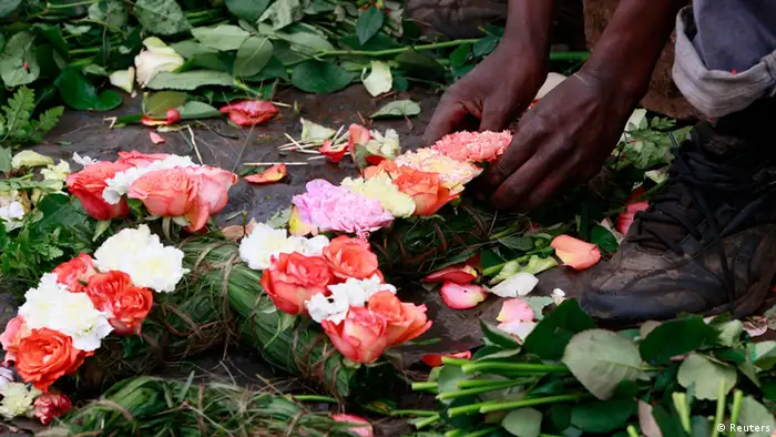 A trader prepares flowers in the shape of a cross for sale outside the City Mortuary, for the victims who were killed during the attack at the Westgate Shopping Centre in Kenya's capital Nairobi, September 25, 2013. As Kenya began three days of mourning on Wednesday for at least 67 people killed in the siege of a Nairobi mall, it was unclear how many more hostages may have died with the Somali Islamist attackers buried in the rubble. REUTERS/Thomas Mukoya (KENYA - Tags: CIVIL UNREST CRIME LAW)