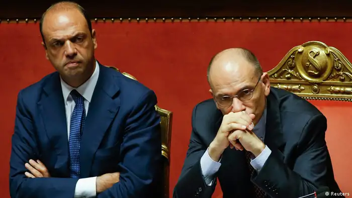 Italy's Prime Minister Enrico Letta (R) looks on next to Interior minister Angelino Alfano during a vote session at the Senate in Rome in this file photo dated July 19, 2013. Italian centre-right leader Silvio Berlusconi pulled his ministers out of the ruling coalition on Saturday, effectively bringing down the government of Prime Minister Enrico Letta and leaving Europe's third-largest economy in chaos. REUTERS/Remo Casilli/Files (ITALY - Tags: POLITICS)