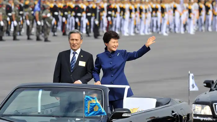 South Korean President Park Geun-Hye (R) waves as she inspects troops with Defence Minister Kim Kwan-Jin during a ceremony marking the 65th anniversary of the founding of South Korea's Armed Forces at an air base in Seongnam, south of Seoul October 1, 2013. REUTERS/Jung Yeon-je/Pool (SOUTH KOREA - Tags: POLITICS MILITARY)