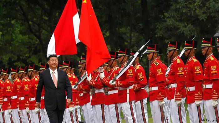 China's President Xi Jinping walks during a welcoming ceremony at the Presidential Palace in Jakarta October 2, 2013. Xi is on a two-day visit to Indonesia. REUTERS/Supri (INDONESIA - Tags: POLITICS)
