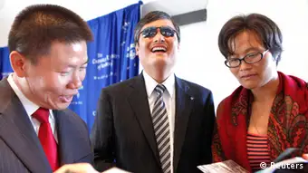 Chinese dissident Chen Guangcheng (C) laughs with wife Yuan Weijing and friend Bob Fu, president of Christian activist group ChinaAid, before a news conference at the National Press Club in Washington October 2, 2013. Chen, the Chinese dissident and legal rights activist who accused New York University of forcing him to leave this summer because of alleged pressure from the Chinese government, will be joining The Witherspoon Institute, a conservative think tank. REUTERS/Yuri Gripas (UNITED STATES - Tags: POLITICS PROFILE TPX IMAGES OF THE DAY)