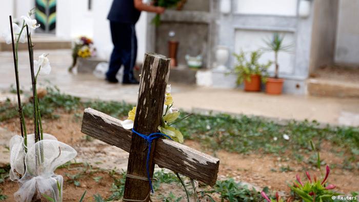 A wooden cross is seen in a cemetery in Lampedusa October 6, 2013. Divers began the recovery of dozens of migrants' bodies on Sunday from a boat that sank last week off the coast of Sicily in one of the worst such disasters to hit people fleeing violence, poverty and oppression in Africa. About 500 migrants were packed onto the boat, which caught fire and capsized on Thursday, according to survivors. More than 200 are still missing, 111 bodies have been recovered and authorities say many will never be found. REUTERS/Antonio Parrinello (ITALY - Tags: DISASTER)