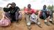 Three African immigrants take a break on the road to Oujda, Morocco Three African immigrants take a break on the road to Oujda, Morocco