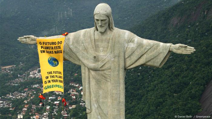 The future of the planet is in your hands - banner on the statue of Christ in Rio de Janeiro