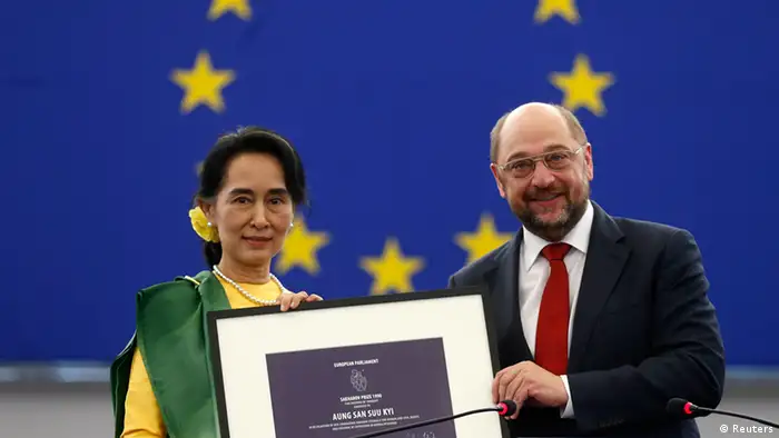Myanmar pro-democracy leader Aung San Suu Kyi (L) holds her 1990 Sakharov Prize, besides European Parliament President Martin Schulz during an award ceremony in Strasbourg, October 22, 2013. The European Parliament awarded its top human rights prize in 1990 to Aung San Suu Kyi, who was then not allowed to leave her country to attend the ceremony. REUTERS/Vincent Kessler (FRANCE - Tags: POLITICS TPX IMAGES OF THE DAY)