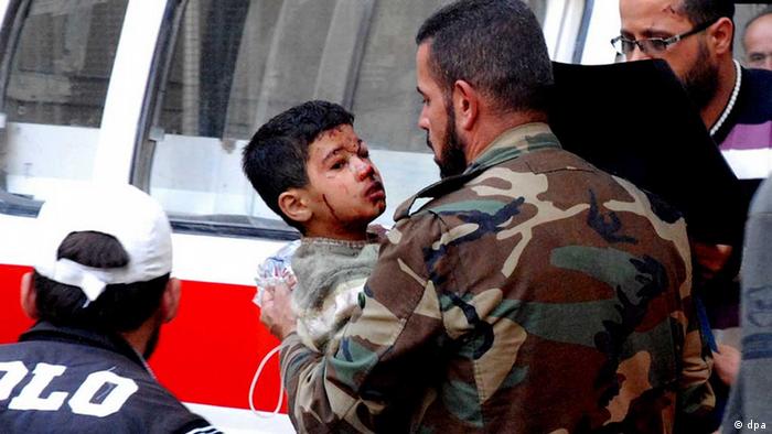 A handout picture made available by Syrian news agency (SANA) shows a Syrian soldier carrying a wounded child to receivE first aid at Al Muwasat Hospital in Damascus, after injured at the site of a car bomb attack near Osama bin Zaid Mosque in Souk Wadi Barada in Rural Damascus, Syria, 25 October 2013. dpa/EPA/SANA HANDOUT /eingest. sc