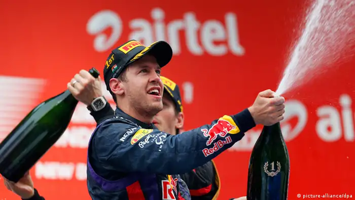 epa03926553 German Formula One driver Sebastian Vettel of Red Bull Racing celebrates on the podium after winning the 4th consecutive Formula One Championship title at the Buddh International Circuit on the outskirts of New Delhi, India, 27 October 2013. EPA/VALDRIN XHEMAJ +++(c) dpa - Bildfunk+++