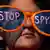 WASHINGTON, DC - OCTOBER 26, 2013: A woman wearing oversized sunglasses lettered with the words "stop spying" listens to speakers during the Stop Watching Us Rally protesting surveillance by the U.S. National Security Agency, on October 26, 2013, in front of the U.S. Capitol building in Washington, D.C. The rally began at Union Station and included a march that ended in front of the U.S. Capitol building and speakers such as author Naomi Wolf and former senior National Security Agency senior executive Thomas Drake. (Photo by Allison Shelley/Getty Images)