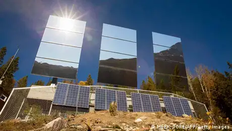 Three giant mirrors erected on the mountainside above Rjukan, Norway, reflect sunshine (photo: MEEK, TORE/AFP/Getty Images)