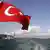 A Turkish flag flies near the Kemal Ataturk Bridge in Instanbul