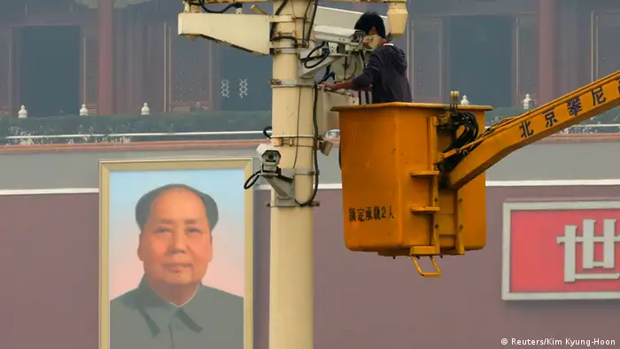 A man works on a security camera that was installed at Tiananmen Square in Beijing, November 1, 2013. China's domestic security chief believes a fatal vehicle crash in Beijing's Tiananmen Square in which five died was planned by a Uighur separatist group, designated as a terrorist organization by the United States and United Nations. Meng Jianzhu, a member of the 25-member Politburo responsible for domestic security, said the East Turkestan Islamic Movement was behind the attack. This is the first time Beijing has accused the group of carrying out the attack. REUTERS/Kim Kyung-Hoon (CHINA - Tags: CRIME LAW POLITICS CIVIL UNREST)