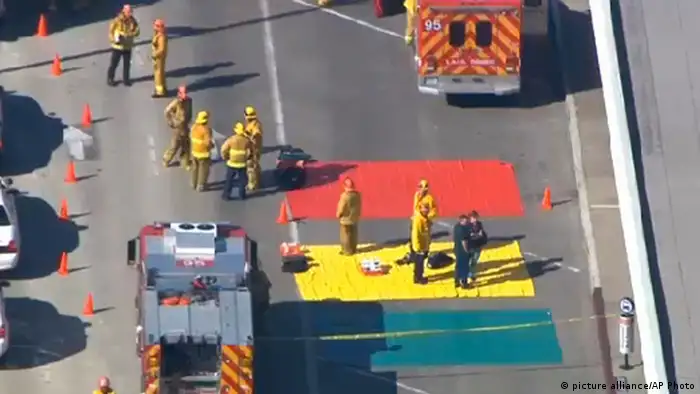 In this aerial video frame grab provided by CBS-LA, fire and rescue personnel gather at Los Angeles International Airport on Friday Nov. 1, 2013. Shots were fired Friday at Los Angeles International Airport, prompting authorities to evacuate a terminal and stop flights headed for the city from taking off from other airports. (AP Photo/CBS-LA)