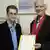 Green politician Hans-Christian Ströbele with Edward Snowden, holding open letter