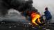 Burning tires, black clouds of smoke fill the sky Burning tires, black clouds of smoke fill the sky