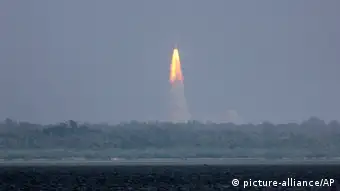 The Polar Satellite Launch Vehicle (PSLV-C25) rocket lifts off carrying India's Mars spacecraft from the east coast island of Sriharikota, India, Tuesday, Nov. 5, 2013. India on Tuesday launched its first spacecraft bound for Mars, a complex mission that it hopes will demonstrate and advance technologies for space travel. The 1,350-kilogram (3,000-pound) Mangalyaan orbiter was headed first into an elliptical orbit around Earth, after which a series of technical maneuvers and short burns will raise its orbit before it slingshots toward Mars. (AP Photo/Arun Sankar K)