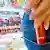 A woman pockets cosmetics in a drug store