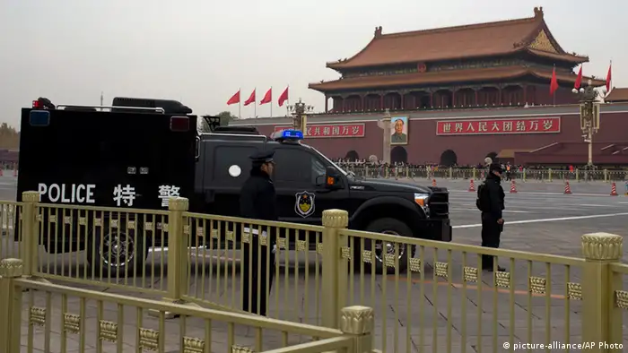 Chinese policemen stand guard near Tiananmen Gate as the 205-member Central Committee's third annual plenum is held in Beijing Saturday, Nov. 9, 2013. Reform advocates are looking to China's leaders to launch a new era of change by giving entrepreneurs a bigger role in the state-dominated economy and farmers more control over land at a policymaking conference that opened Saturday. (AP Photo/Andy Wong)