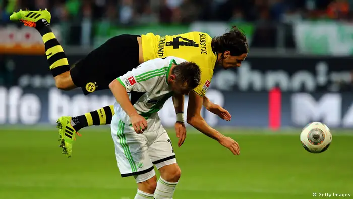 Ivica Olic of Wolfsburg and Neven Subotic of Dortmund battle for the ball 