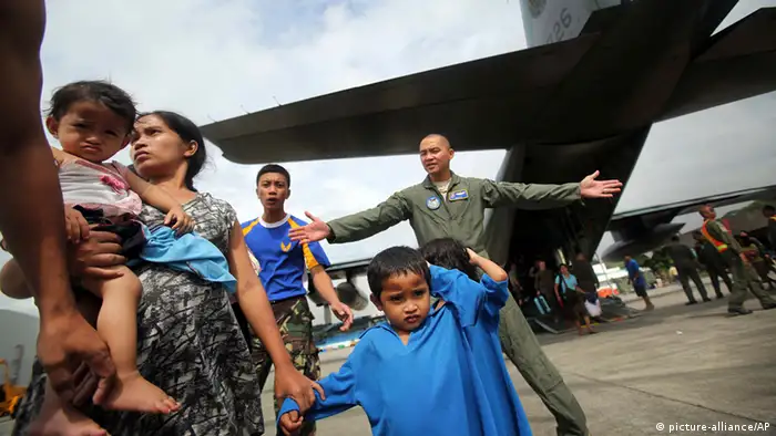 Survivors of Typhoon Haiyan disembark a Philippine Airforce C-130 aircraft at Villamor Airbase, Tuesday, Nov. 12, 2013 in Manila, Philippines. Authorities said at least 9.7 million people in 41 provinces were affected by the typhoon, which was likely the deadliest natural disaster to beset this poor Southeast Asian nation. (AP Photo/Wong Maye-E)