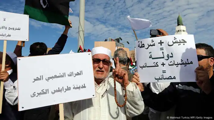 Libyan protesters gather during a demonstration calling on militiamen to vacate their headquarters in southern Tripoli on November 15, 2013. Hundreds of people in the Gharghour district converged on the Misrata militia's headquarters to press their demands when gunmen opened fire on the crowd wounding at least two people, an AFP journalist witnessed. AFP PHOTO/MAHMUD TURKIA (Photo credit should read MAHMUD TURKIA/AFP/Getty Images)