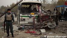 An Afghan policeman secures an area after a suicide vehicle bomb tore through the area on the outskirts of Kabul, Saturday, Nov. 16, 2013. The explosion came just hours after President Hamid Karzai announced that U.S. and Afghan negotiators had finished a draft to be presented to the Loya Jirga, whom Kabul says must approve the document before Afghanistan signs it. (AP Photo/Anja Niedringhaus)