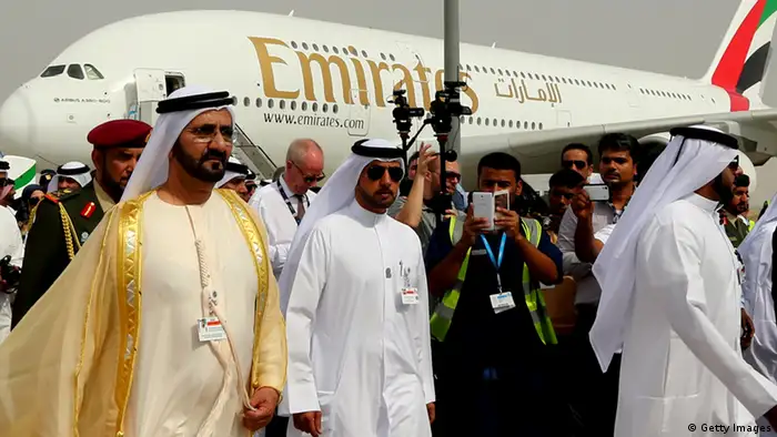 Ruler of Dubai Sheikh Mohammed Bin Rashid al-Maktoum (L) walks past an Emirates Airline's Airbus A380 as he attends the opening ceremony of the Dubai Airshow on November 17, 2013. AFP PHOTO/MARWAN NAAMANI (Photo credit should read MARWAN NAAMANI/AFP/Getty Images)