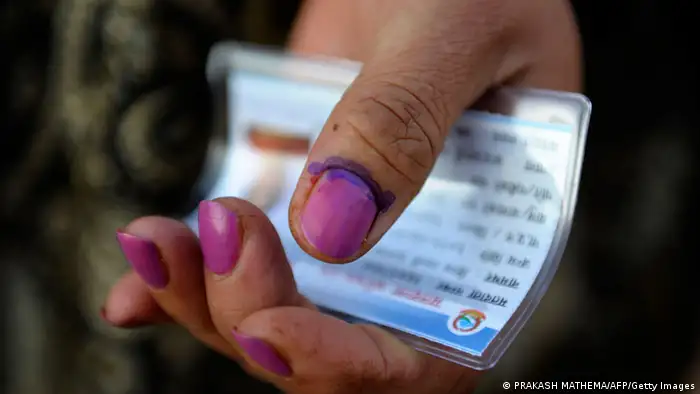 A Nepalese woman shows her finger after election official marked it with indelible ink at a polling station in Kathmandu on Novemeber 19, 2013. Polling stations in Nepal opened for elections that will be crucial in completing a peace process stalled for several years since the end of a decade-long civil war. AFP PHOTO/Prakash MATHEMA (Photo credit should read PRAKASH MATHEMA/AFP/Getty Images)