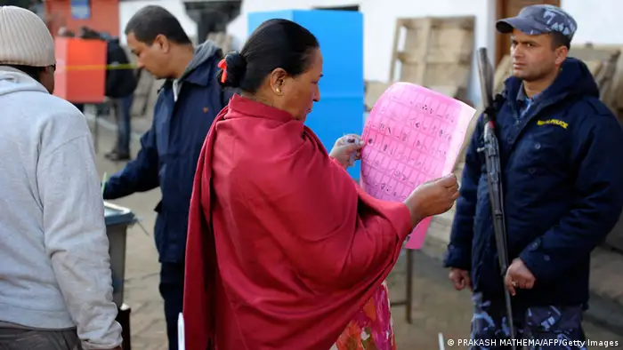 A Nepalese woman looks at a voting paper at a polling station in Kathmandu on November 19, 2013. Polling stations in Nepal opened for elections that will be crucial in completing a peace process stalled for several years since the end of a decade-long civil war. AFP PHOTO/Prakash MATHEMA (Photo credit should read PRAKASH MATHEMA/AFP/Getty Images)