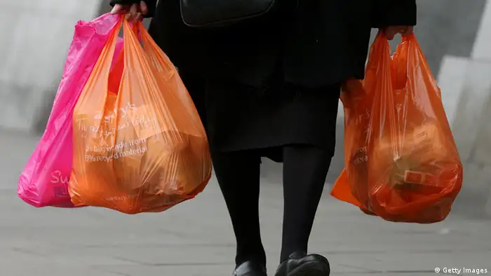 LONDON - FEBRUARY 29: Shoppers leave a Sainsbury's store with their purchases in plastic bags on February 29, 2008 in London, England. The Prime Minister Gordon Brown has stated that he will force retailers to help reduce the use of plastic bags if they do not do so voluntarily. (Photo by Cate Gillon/Getty Images)
