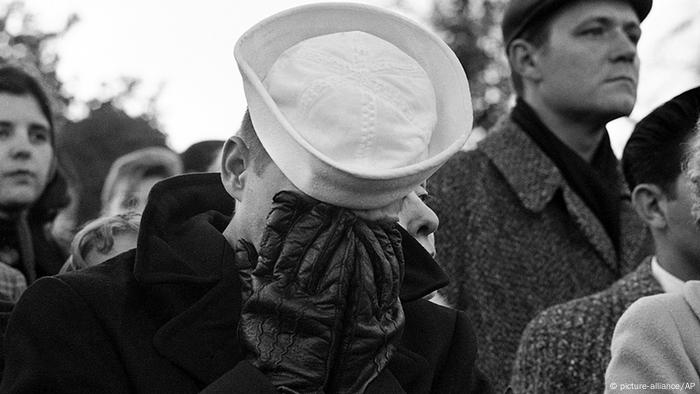 Sailor weeping while the caisson with President John F. Kennedy goes past in Arlington