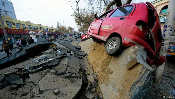 ATTENTION EDITORS - REUTERS PICTURE HIGHLIGHT TRANSMITTED BY 0535GMT ON NOVEMBER 23, 2013 PEK03 A wrecked car is seen lifted onto the side of a damaged road after an explosion in a Sinopec Corp oil pipeline in Huangdao, Qingdao, Shandong Province. REUTERS/Stringer CHINA OUT. NO COMMERCIAL OR EDITORIAL SALES IN CHINA. REUTERS NEWS PICTURES HAS NOW MADE IT EASIER TO FIND THE BEST PHOTOS FROM THE MOST IMPORTANT STORIES AND TOP STANDALONES EACH DAY. Search for TPX in the IPTC Supplemental Category field or IMAGES OF THE DAY in the Caption field and you will find a selection of 80-100 of our daily Top Pictures. REUTERS NEWS PICTURES. TEMPLATE OUT