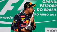 Red Bull Formula One driver Sebastian Vettel of Germany bows as he celebrates winning the Brazilian F1 Grand Prix at the Interlagos circuit in Sao Paulo November 24, 2013. REUTERS/Nacho Doce (BRAZIL - Tags: SPORT MOTORSPORT F1 TPX IMAGES OF THE DAY)