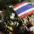 Anti-government protesters, with Thai national flags, gather inside the compound of the Foreign Ministry in Bangkok, Thailand, Monday, Nov. 25, 2013. Anti-government demonstrators in Thailand occupied parts of two government ministries, the finance and foreign ministries, on Monday, turning up the pressure in their offensive against the administration of Prime Minister Yingluck Shinawatra. (AP Photo/Sakchai Lalit) pixel
