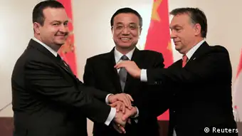 Prime Ministers Ivica Dacic (L) of Serbia and Viktor Orban (R) of Hungary shake hands with China's Premier Li Keqiang after a joint news conference in Bucharest November 25, 2013. REUTERS/Radu Sigheti (ROMANIA - Tags: POLITICS TPX IMAGES OF THE DAY)