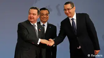 Serbia's Prime Minister Ivica Dacic (L) is welcomed by China's Premier Li Keqiang and Romanian Prime Minister Victor Ponta (R) at the meeting of heads of government from Central and Eastern European countries and China in the lobby of the Parliament building in Bucharest November 26, 2013. REUTERS/Bogdan Cristel (ROMANIA - Tags: POLITICS)