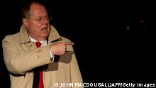 Peer Steinbrueck of the German Social Democrats (SPD) gestures as he arrves at the SPD's headquarters on his way to coalition talks between members of Christian Democratic Union (CDU), its Bavarian allies the CSU and the Social Democrats (SPD) in Berlin on November 26, 2013. German coalition talks are in session to overcome still thorny differences and agree on a left-right government. A clutch of negotiators from her Christian Democratic Union (CDU), its Bavarian allies the CSU and the Social Democrats (SPD) met in Berlin with pressure mounting before a full-table session, which was delayed and expected to run well into the morning hours. AFP PHOTO / JOHN MACDOUGALL (Photo credit should read JOHN MACDOUGALL/AFP/Getty Images)