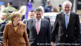 (L-R) German Chancellor Angela Merkel, Sigmar Gabriel, leader of Germany's social democratic SPD party, CSU chairman and Bavarian State Premier Horst Seehofer walk through a corridor at Willy Brand-Haus, SPD's headquarters, for talks between German Chancellor's conservative CDU/CSU union and the social democratic SPD in the aim of forming a coalition government in Berlin on October 30, 2013. AFP PHOTO /JOHN MACDOUGALL (Photo credit should read JOHN MACDOUGALL/AFP/Getty Images)
