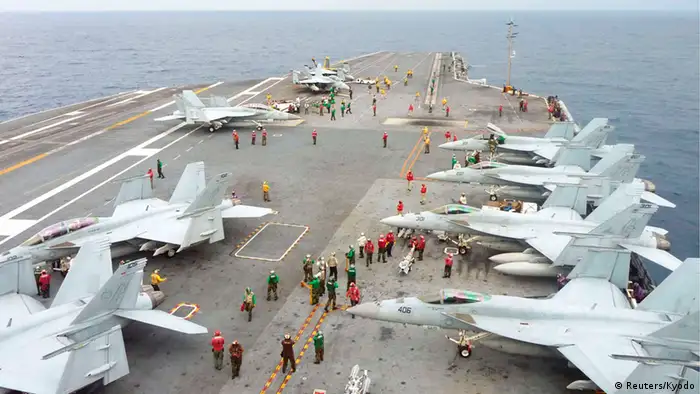 U.S. Navy FA-18 Hornets park on the flight deck of the USS George Washington during the Annual Exercise 2013, at sea November 28, 2013. The USS George Washington took part in a joint military naval drill with Japan on Thursday in waters off southern Japan, just days after it participated in humanitarian relief operations in the Philippines. More than 20 ships and 7,000 U.S. personnel participated in this year's exercise which aims at strengthening ties between the U.S. Navy and the Japan Maritime Self Defence force. While the U.S. Navy would not confirm the exact coordinates, they were able to say the event took place, at one point at least, some 300 km (186 miles) south east of Japan's southern most the islands of Okinawa. This is in the general vicinity, though not within, the new airspace defense zone which China newly established last week. Mandatory credit REUTERS/Kyodo (JAPAN - Tags: MILITARY POLITICS TRANSPORT MARITIME) ATTENTION EDITORS - FOR EDITORIAL USE ONLY. NOT FOR SALE FOR MARKETING OR ADVERTISING CAMPAIGNS. THIS IMAGE HAS BEEN SUPPLIED BY A THIRD PARTY. IT IS DISTRIBUTED, EXACTLY AS RECEIVED BY REUTERS, AS A SERVICE TO CLIENTS. MANDATORY CREDIT. JAPAN OUT. NO COMMERCIAL OR EDITORIAL SALES IN JAPAN. YES
