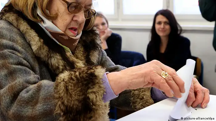 epa03972393 An elderly woman casts her vote into a ballot box at a polling station in Zagreb 01 December 2013,during the national referendum which is asking Croats to constitutionally define marriage as a union between a man and woman, preventing the possibility of same sex marriages. EPA/ANTONIO BAT